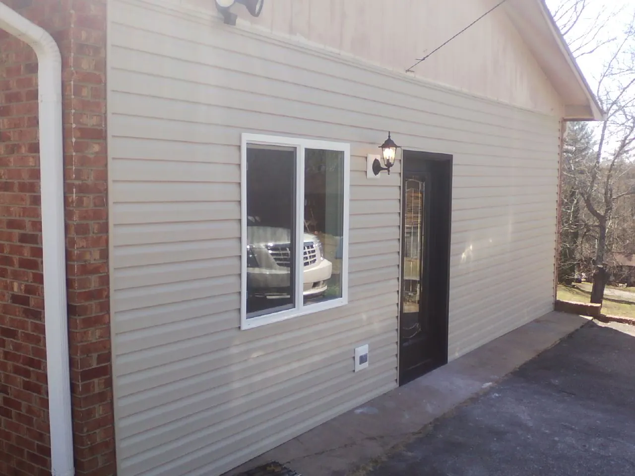 New vinyl siding and entry door on a room addition in Summit